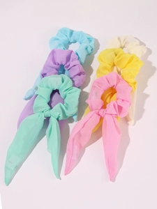 Detailed set of six pastel chiffon hair scrunchies with long ribbon bows on white background