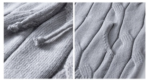 Detail showing grey cable-knit texture and drawstrings on a thick oversized hoodie