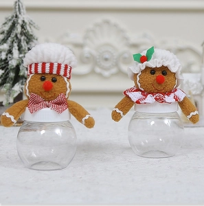 Macro shot of gingerbread man candy jars with festive red and white striped decorations