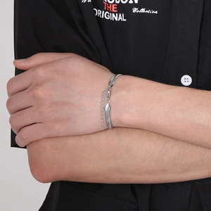 Detail of silver stainless steel flat snake chain bracelet with adjustable extender on wrist