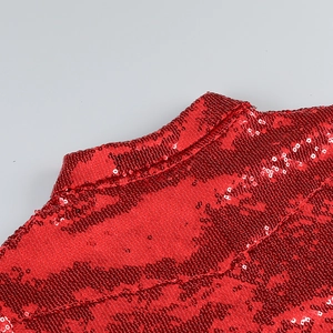 Close-up of red sequin collar and shoulder details on a sequined two-piece set
