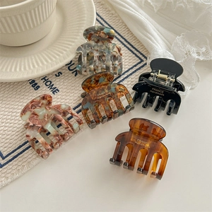 French style acetate claw clips set in marble and tortoise patterns with handmade logo