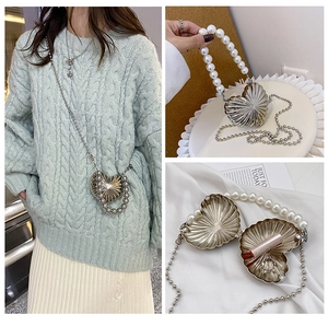 Silver heart-shaped metal mini bag with pearl handle and inner lipstick storage