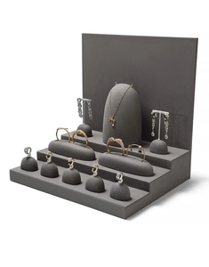 Macro view of a tiered microfiber jewelry display set for necklaces and rings