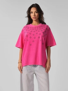 Detailed macro view of the vintage rhinestone H-pattern on rose red cotton T-shirt