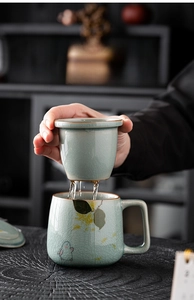 Detailed view of hand-painted rabbit ceramic tea mug with strainer and ice-crackle glaze