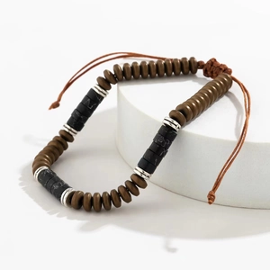 Detail of beaded bracelet showing brown and black stones with an adjustable braided cord