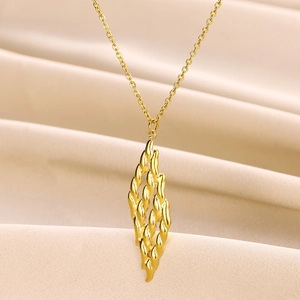 Detail view of double-layered 18K gold stainless steel necklace with hollow heart pendant
