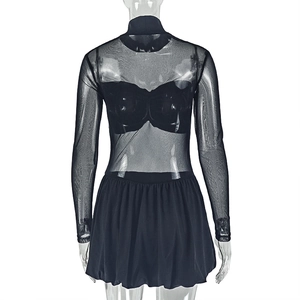 Detail of sheer black mesh high neck top with long sleeves and pleated mini skirt