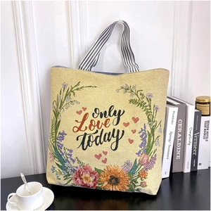 Detail view of canvas tote bag with floral embroidery and only Love today text