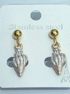 Close-up of golden stainless steel ball earrings with silver shell charms on card