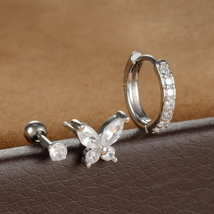 Detailed macro shot of a 3-piece silver butterfly and cubic zirconia stud earring set