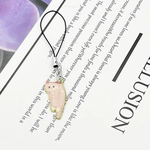 Pink cartoon cat enamel charm with silver lobster clasp on a minimalist paper background