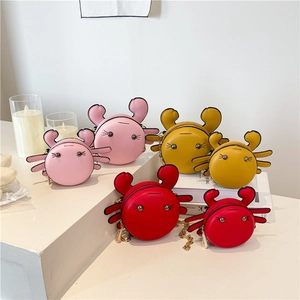 Crab-shaped crossbody bags with gold chains in pink, yellow, and red colors