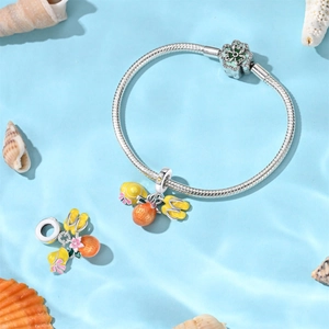 Macro detail of silver vacation charm bracelet featuring a sun hat and floral enamel beads
