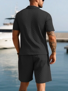 Rear view of black jacquard polo shirt and shorts set with geometric texture