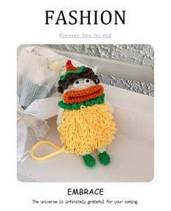 Close-up of yellow handmade crochet phone bag with creative sausage mouth design