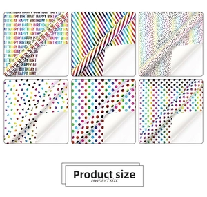 Close-up of rainbow birthday wrapping paper with colorful dots, stripes and heart patterns