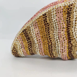 Macro shot of colorful rhinestone stripes and sparkling crystals on a luxury evening clutch