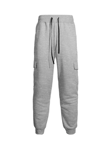 Detail of grey joggers featuring drawstring elastic waist and functional cargo flap pockets