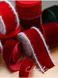 Detail of red Christmas velvet ribbon with white faux fur edges for gift wrapping