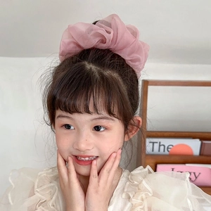 Elegant pink chiffon scrunchie hair tie for women and girls shown on a child model