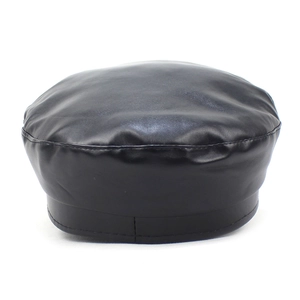 Detail of a black PU leather baker boy hat showing the smooth glossy texture and curved brim