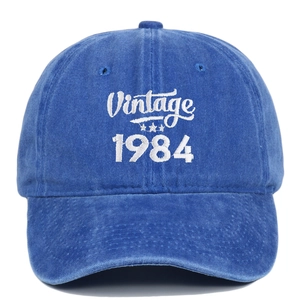 Detailed view of the 1984 Vintage white embroidery on distressed blue cotton baseball cap