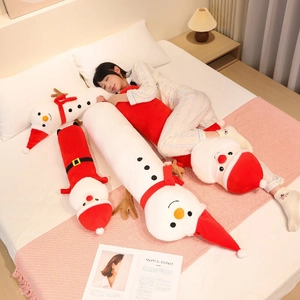 Macro detail of plush Santa Claus and snowman bolster pillows with soft fabric texture
