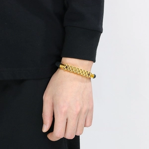 Men's industrial stainless steel gear bracelet with gold finish and black strap