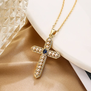 Gold-plated cross necklace with white pearls, blue gemstone and zircon on silk fabric