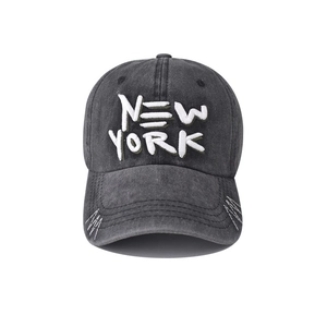 Detailed view of New York embroidery and distressed stitching on a washed cotton baseball cap