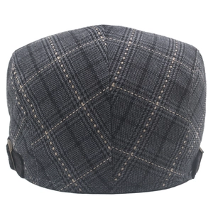 Detailed view of gray plaid newsboy hat featuring textured tweed fabric and side buckle