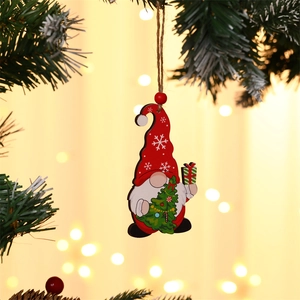Detail of wooden gnome ornament with red snowflake hat and green gift for Christmas tree