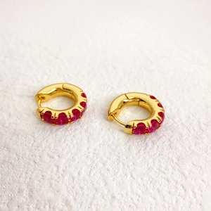 Elegant gold hoop earrings with red zircon stones in a vintage circular design