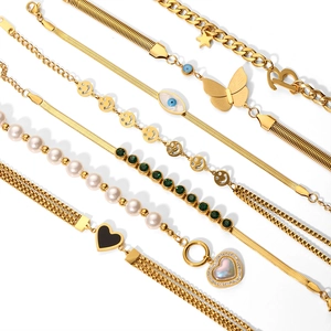 Elegant gold titanium steel bracelet set featuring heart pendants and sparkling zircon stones