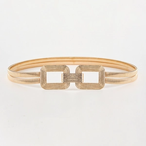 Detail of gold elastic waist chain showing double rectangular buckle and brushed texture