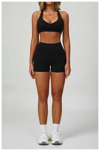 Front view of black racerback sports bra and high-waisted shorts set for yoga fitness