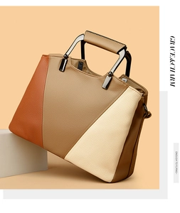 Detail of color-block tote bag featuring lychee grain leather and geometric metal handle