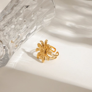 Gold daisy stainless steel open ring with shadow lighting effect on white surface