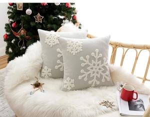 Detailed embroidery of white snowflakes on soft grey Christmas decorative pillow covers