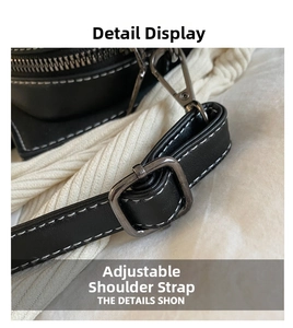 Detail view of the adjustable shoulder strap on a black bat bag with white stitching