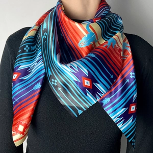Western style silk scarf with vibrant geometric patterns and arrows on model