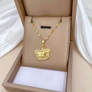 Gold titanium steel crown bear necklace with crystals on a jewelry box