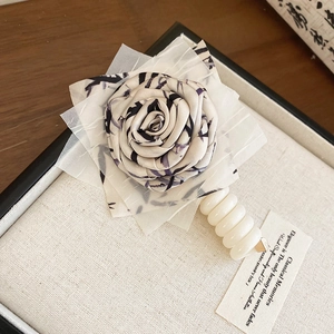 Elegant fabric rose hair tie with unique telephone wire band, sweet floral hair accessory.