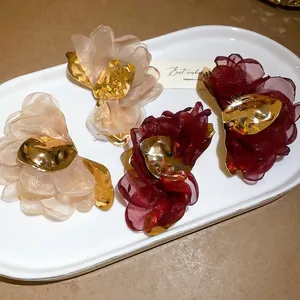 Elegant champagne and burgundy tulle floral hair clips with golden metallic accents