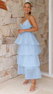 Close-up of light blue layered ruffle cake dress with thin straps and a deep V-neckline