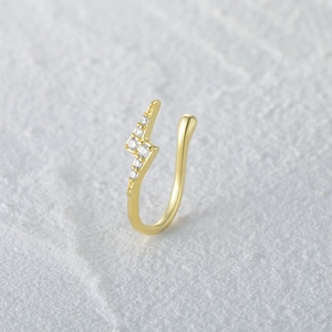 Close-up of golden S925 sterling silver geometric lightning nose cuff with pavé zircons