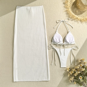 Detailed flat lay of cream waffle knit bikini set with matching long mesh beach skirt