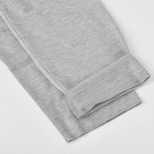 Detailed close-up of grey knitted fabric texture on sleeve cuff with folded edge detail